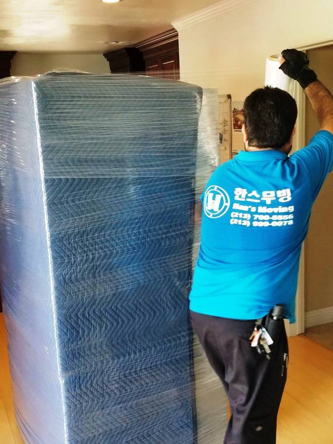 Han's Moving mover shrink-wrapping furniture before the move
