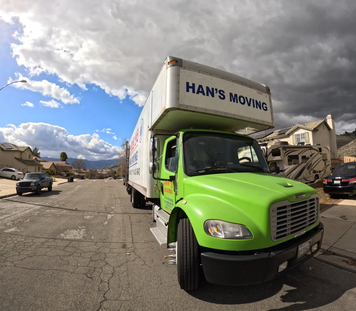 Han's Moving box truck parked on a residential street before a move